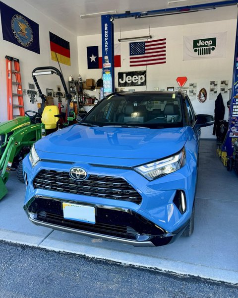 Blue SUV in the Shattered Vision shop for windshield replacement, Colorado Springs