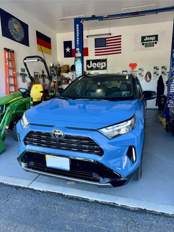 Blue SUV in the Shattered Vision shop for windshield replacement, Colorado Springs