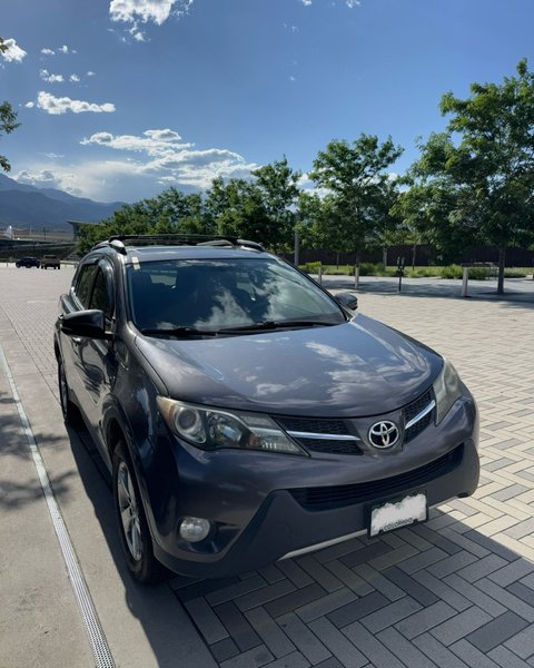 Gray SUV parked on a Colorado Springs driveway after auto glass service