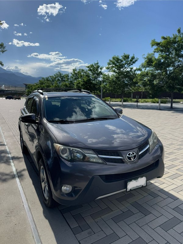 Gray SUV parked on a Colorado Springs driveway after auto glass service