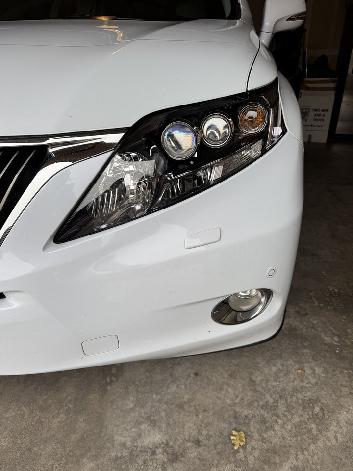 After: same SUV headlight restored to clear factory clarity by Shattered Vision Auto Glass, Colorado Springs