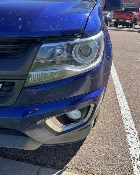Headlight restoration on a blue SUV in Colorado Springs