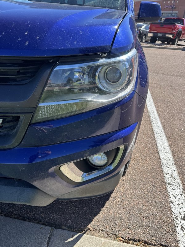 Headlight restoration on a blue SUV in Colorado Springs
