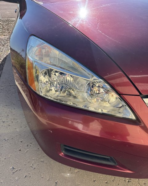 Headlight restoration on a maroon sedan in Colorado Springs