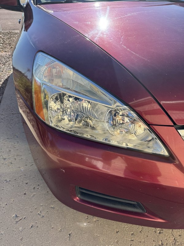 Headlight restoration on a maroon sedan in Colorado Springs
