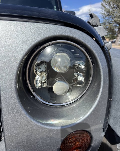 Restored projector headlight on a silver vehicle in Colorado Springs