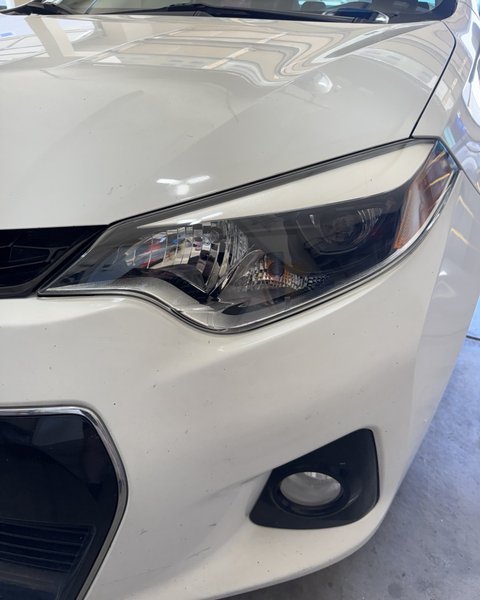 Restored clear headlight on a white sedan in Colorado Springs