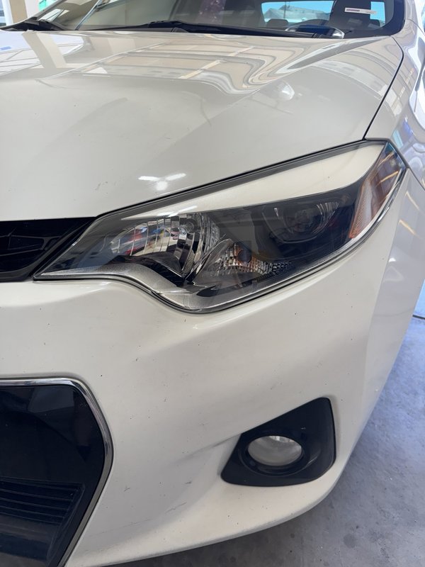 Restored clear headlight on a white sedan in Colorado Springs