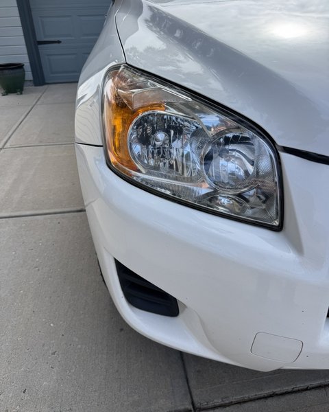 Clear restored headlight on a white SUV in Colorado Springs
