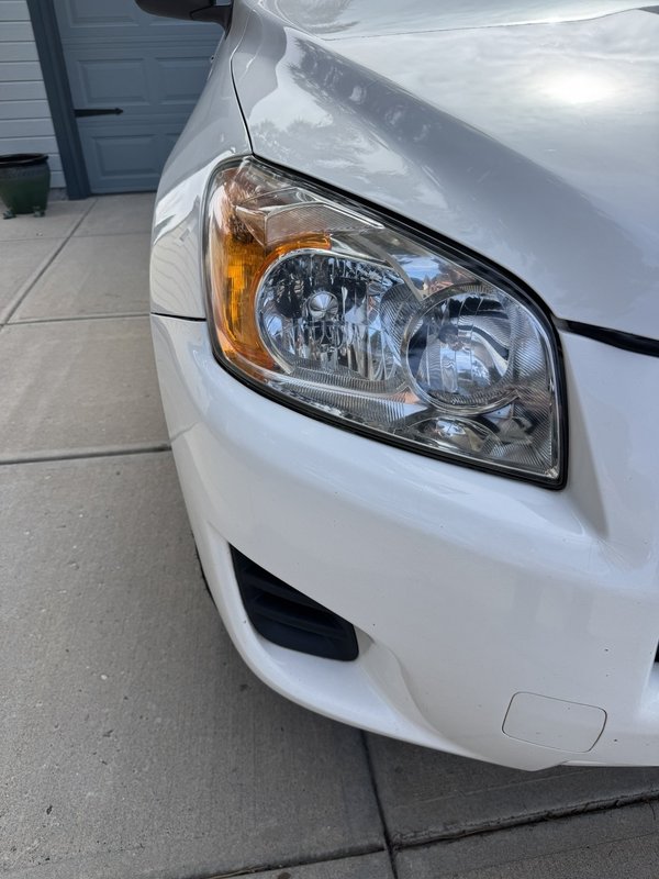Clear restored headlight on a white SUV in Colorado Springs
