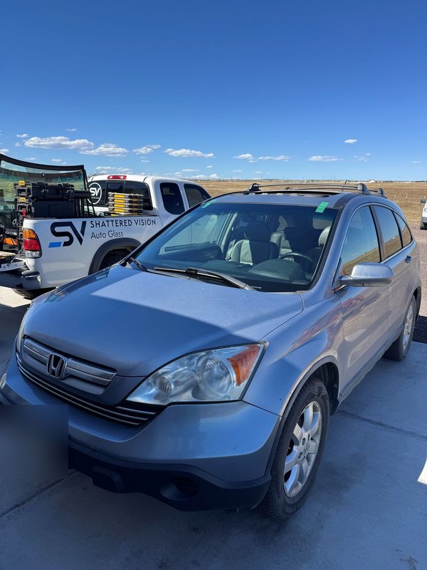 Honda CR-V beside the Shattered Vision service truck after mobile windshield replacement in Colorado Springs