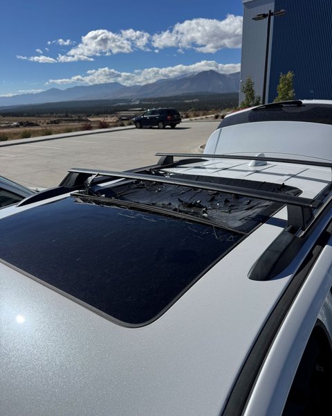 Panoramic sunroof glass removed from a silver SUV during roof glass replacement in Colorado Springs