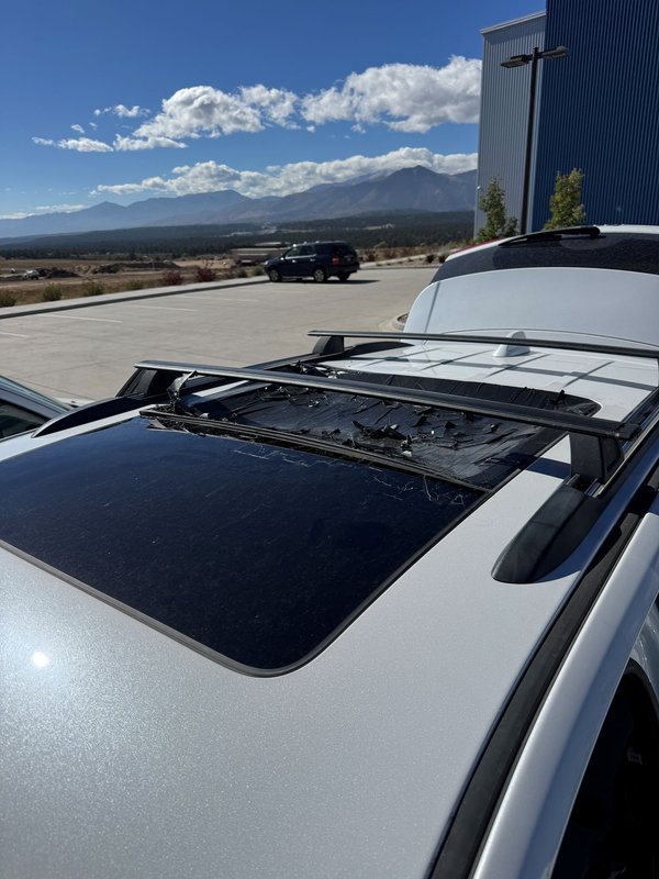 Panoramic sunroof glass removed from a silver SUV during roof glass replacement in Colorado Springs
