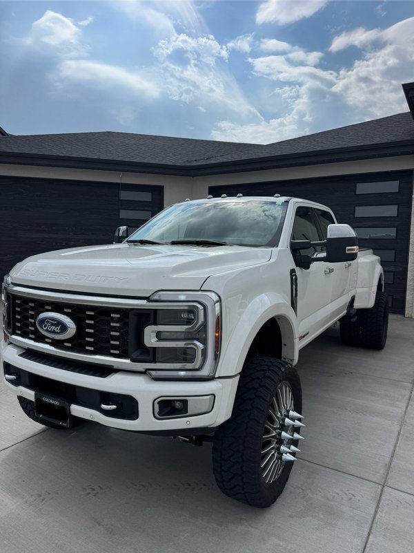 White lifted dually pickup after windshield replacement in Colorado Springs