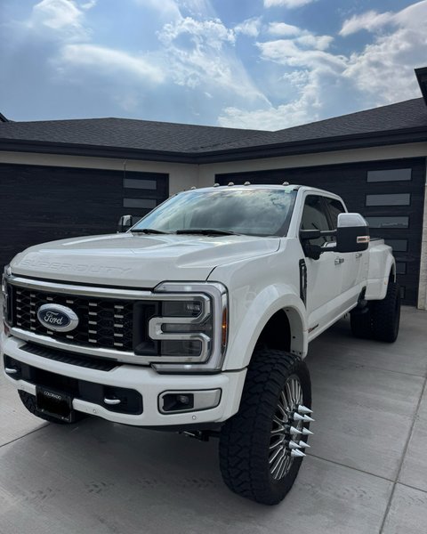 White lifted dually pickup after windshield replacement in Colorado Springs