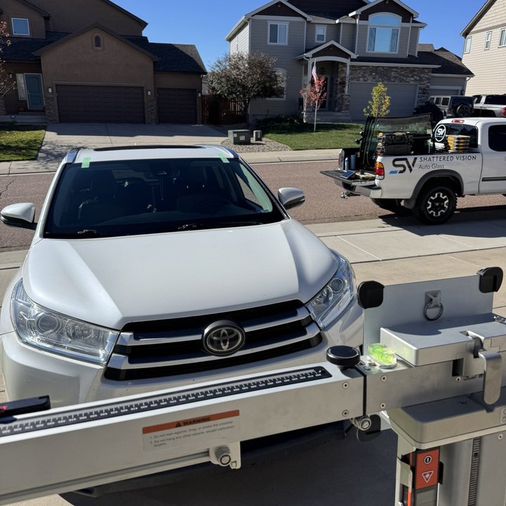 Shattered Vision Auto Glass performing mobile ADAS calibration on a white SUV in Colorado Springs