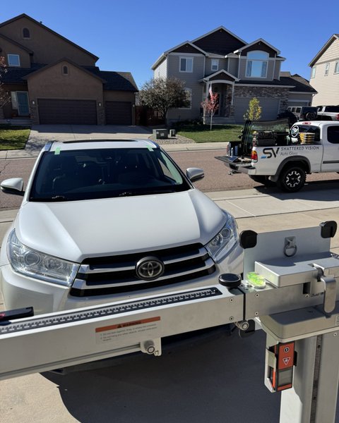 White SUV set up for mobile ADAS calibration with Shattered Vision equipment, Colorado Springs