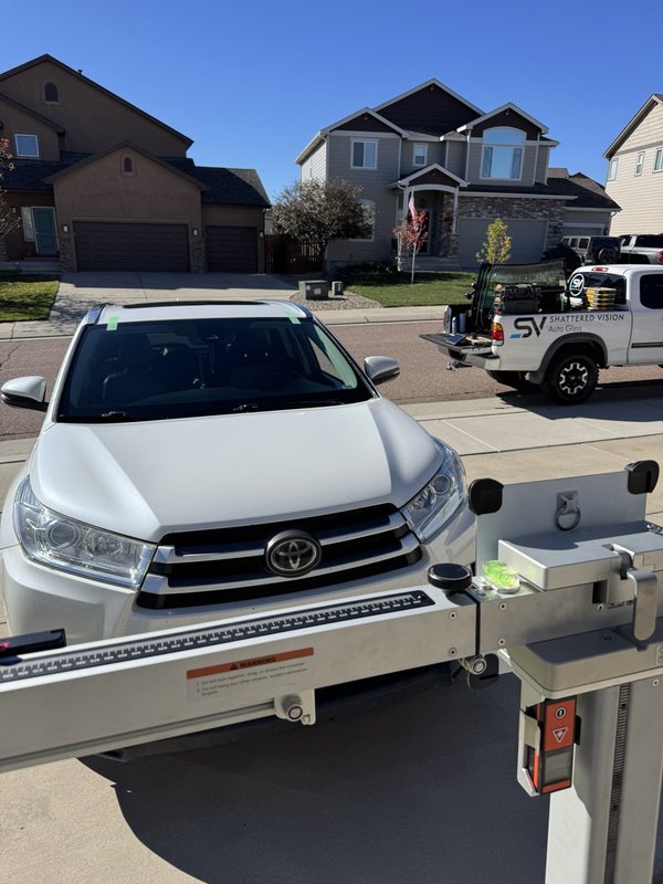 White SUV set up for mobile ADAS calibration with Shattered Vision equipment, Colorado Springs