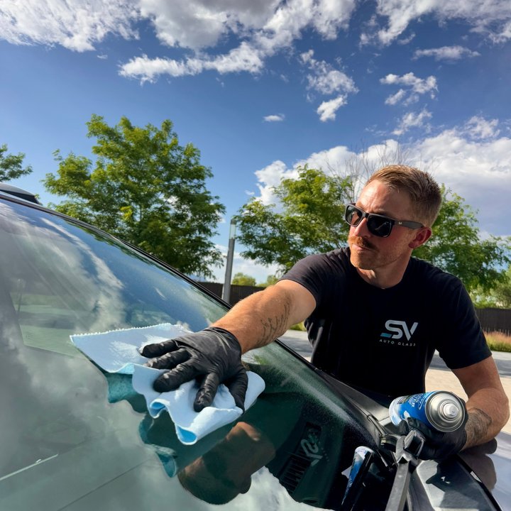 Shattered Vision Auto Glass Master Technician completing final cleaning on a newly installed windshield in Colorado Springs
